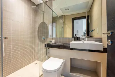 a bathroom with a toilet and a sink at StayShort - Dubai Marina sleeps 4 with Water Views! in Dubai