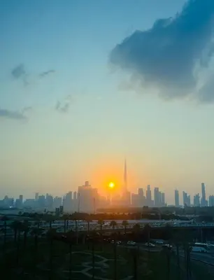 a view of a city skyline at sunset at Elegant Apartment with Burj Khalifa View in Dubai