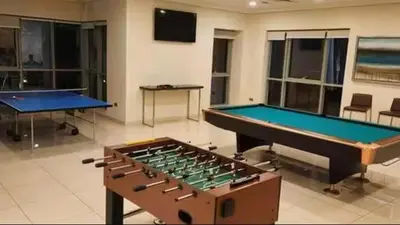 two ping pong tables in a large room with at Vogue Downtown Boulevard Central near Burj Khalifa and Dubai Mall, Two Bedroom Apartment with Balcony and Burj Khalifa View, Access to all Amenities in Dubai