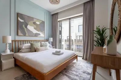 a bedroom with a bed and a large window at GuestReady - Coastal Style l 2Bed l Lagoon Escape in Dubai