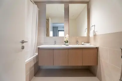 a bathroom with a sink and a mirror at GuestReady - Coastal Style l 2Bed l Lagoon Escape in Dubai