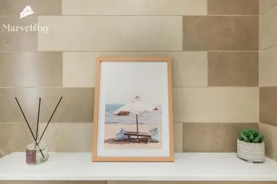 a picture of a beach chair with an umbrella at MarvelStay-Infinity Pool-Beachfront-The Palm in Dubai