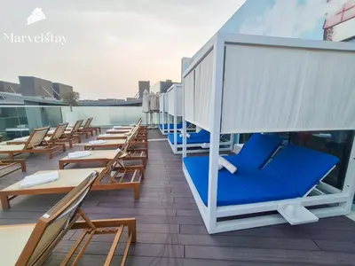 a row of chairs and tables on a rooftop deck at MarvelStay-Infinity Pool-Beachfront-The Palm in Dubai