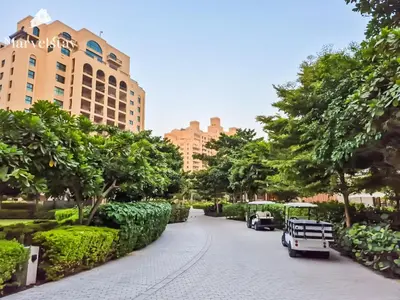 a street in a park with trees and buildings at MarvelStay-Infinity Pool-Beachfront-The Palm in Dubai