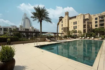 a large swimming pool in a city with buildings at StayMada - Lamtara Near Burj AlArab Beach Access in Dubai