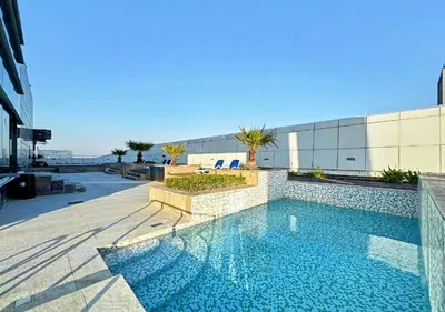 a swimming pool on the side of a building at Cosmos Living Majestic Studio GCV2 in Dubai