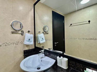 a bathroom with a sink and a mirror at Cosmos Living Majestic Studio GCV2 in Dubai