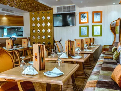 a restaurant with tables and chairs in a room at Cosmos Living Majestic Studio GCV2 in Dubai