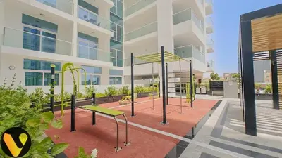 a playground in front of a building at Vogue Al Furjan Pearlz by Danube near Ibn Battuta Mall, Three Bedroom plus Kids room Apartment with Balcony and Private pool, Access to all Amenities, Walkable to Al Furjan Metro Station in Dubai