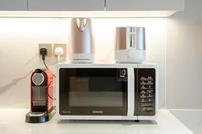 a microwave oven with a blender on top of it at PVH - Burj Khalifa View Studio - Emaar Residence Fashion Avenue in Dubai