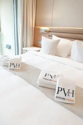 two beds in a hotel room with towels on them at PVH - Burj Khalifa View Studio - Emaar Residence Fashion Avenue in Dubai