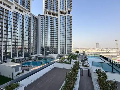 a view of a building with a swimming pool and buildings at Luxury 2BR in Sobha Hartland in Dubai