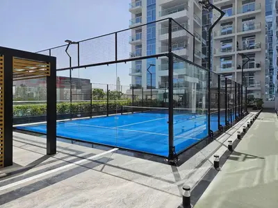 a tennis court on the roof of a building at Vogue Al Furjan Pearlz by Danube near Ibn Battuta Mall, One Bedroom Apartment with Balcony and Pool View, Access to all Amenities, Walkable to Al Furjan Metro Station in Dubai