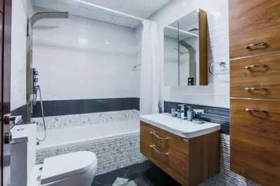 a bathroom with a toilet and a tub and a sink at Modern and Spacious 2BR in Glamz, Al Furjan in Dubai