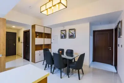 a dining room with a table and chairs at Modern and Spacious 2BR in Glamz, Al Furjan in Dubai