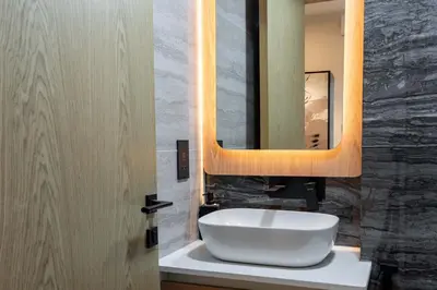 a bathroom with a white sink and a mirror at TRPS - Alef Noon, JVC - Brand New - Luxury Furnished 1BR - Prime JVC Location in Dubai