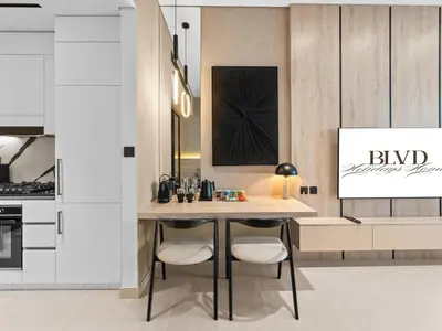 a kitchen with a table and chairs in a room at BLVD - Stylish Stay with Private Jacuzzi and Canal View in Dubai
