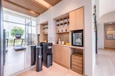 a kitchen with stainless steel appliances and a tv at Luxury 1BR Stay, Connected to Dubai Mall and Burj Khalifa, Vida Dubai Mall Tower 2, Downtown Dubai by Deluxe Holiday Homes in Dubai