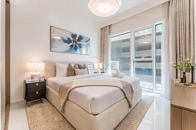 a bedroom with a large bed and a window at Partial Sea Views with Private Beach Access, Near Dubai Marina and Palm Jumeirah, Grand Bleu Tower by Elie Saab, Tower 2, Emaar Beachfront by Deluxe Holiday Homes in Dubai
