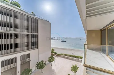 a view of the ocean from the balcony of a building at Partial Sea Views with Private Beach Access, Near Dubai Marina and Palm Jumeirah, Grand Bleu Tower by Elie Saab, Tower 2, Emaar Beachfront by Deluxe Holiday Homes in Dubai