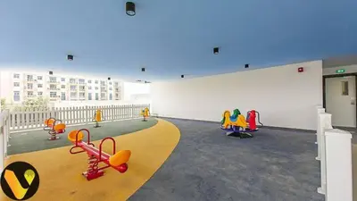 a room with a white wall with a bunch of toys at Vogue Al Furjan Pearlz by Danube near Ibn Battuta Mall, One Bedroom Apartment with Terrace and vibrant community view, Access to all Amenities, Walkable to Al Furjan Metro Station in Dubai