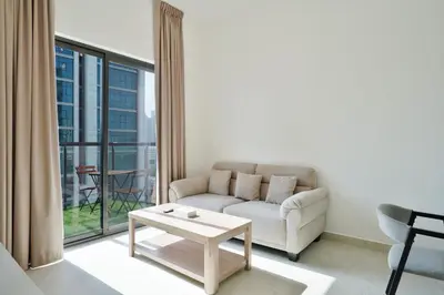 a living room with a couch and a table at Stylish 1BR Retreat Huge Balcony in Dubai