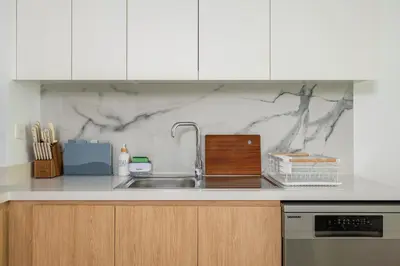 a kitchen with a sink and a counter top at Beach Please in Dubai