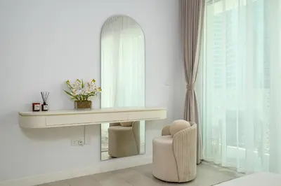 a dressing room with a mirror and a chair at Beach Please in Dubai
