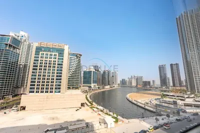 a view of a river in a city with tall buildings at Walking Distance to Bay Avenue Mall, 5 Minutes Drive to Downtown Dubai, Close to Metro Station, With Canal View, The Cosmopolitan, Business Bay by Deluxe Holiday Homes in Dubai