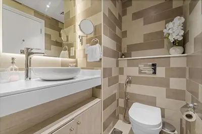 a bathroom with a sink and a toilet at Seven Palm Studio Roof Top Pool Beach Gym for free in Dubai