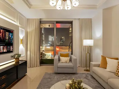 a living room with a couch and a chair at Kensington Perfect 1BR Burj View and Dubai Mall Link in Dubai