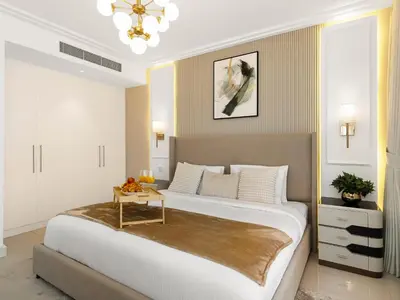 a bedroom with a large bed with a table on it at Kensington Perfect 1BR Burj View and Dubai Mall Link in Dubai