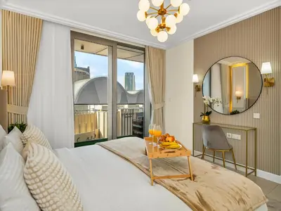a bedroom with a bed and a table with fruit on it at Kensington Perfect 1BR Burj View and Dubai Mall Link in Dubai