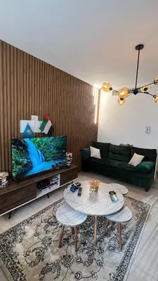a living room with a couch and a table at Expedite Homes in Dubai