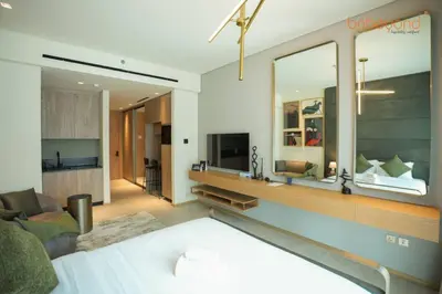 a living room with a large mirror on the wall at The Autograph-Art Meets Comfort in Dubai