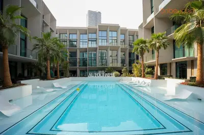 a swimming pool in front of a building at The Autograph-Art Meets Comfort in Dubai