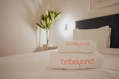two towels sitting on top of a bed at Bnbeyond Ultra-Luxe 2BR with Burj Khalifa Panorama in Dubai