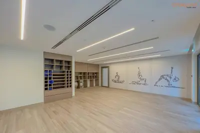 an empty room with a large room with drawings on the wall at Burj Khalifa Light Show from your Bed in Dubai