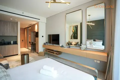 a bedroom with a bed and a large mirror at Signature Stay at The Autograph in Dubai