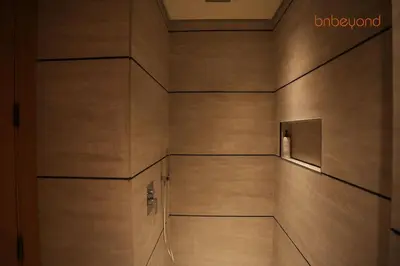 a hallway of a building with wooden walls at Signature Stay at The Autograph in Dubai