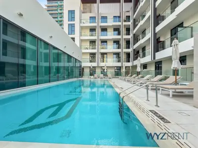 an empty swimming pool in an apartment building at Boho Grecian Studio in JVC Pool & Gym Access in Dubai