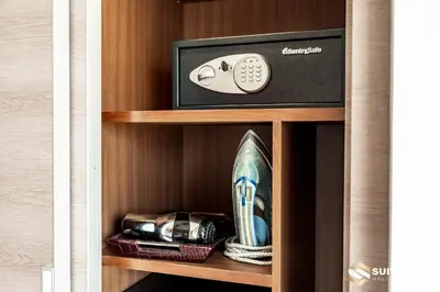 a shelf with a picture and a surfboard in a room at Dubai Mall Apartments by Suitestay in Dubai