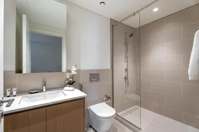 a bathroom with a shower and a toilet and a sink at GuestReady - 1Bed l Lagoon Escape l Creek Beach in Dubai