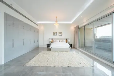 a bedroom with a bed and a large window at Marina Luxury 5 Bedroom & Private Pool in Dubai