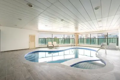 a large room with a swimming pool in a building at Marina Luxury 5 Bedroom & Private Pool in Dubai