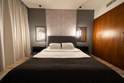 a bedroom with a large bed and wooden cabinets at Full Burj Khalifa Views at Burj Vista in Dubai