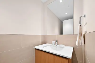 a bathroom with a sink and a mirror at Modern 3BD with Maid's Room near Lagoon at Lotus 4 in Dubai