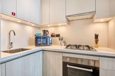 a kitchen with a sink and a stove at STAY BY LATINEM Luxury 1BR Holiday Home CC 0821 Near Downtown in Dubai