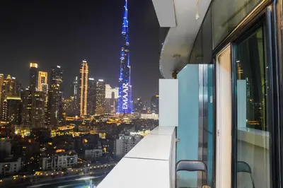 a view of a city skyline at night at Studio with Burj Khalifa view in Dubai