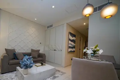 a living room with a couch and a table at Studio with Burj Khalifa view in Dubai